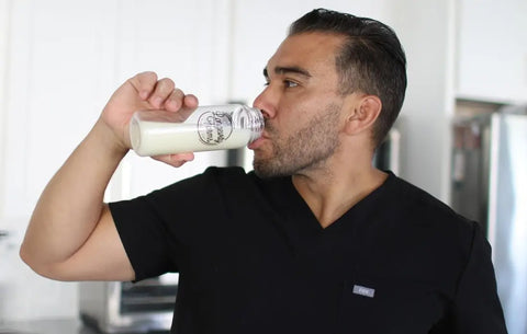 Supplements to support DNA repair being consumed from a Longevity Farms bottle by a man in a black shirt.